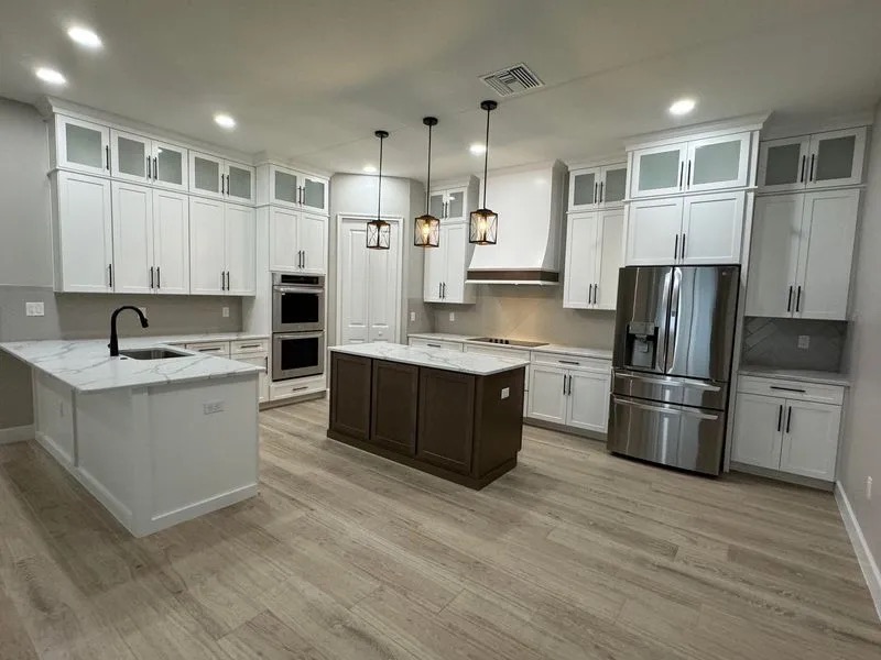 Kitchen refit with shaker cabinetry, quartz counters and a dark island
